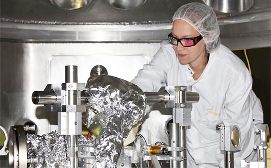 Arianna Gleason makes final adjustments to detector positions inside the Matter in Extreme Conditions 